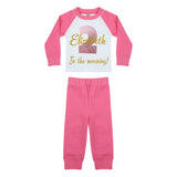 Pink and white solid baby pyjamas that read: Elizabeth 2 in the morning!