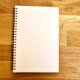 An A5 notebook displaying a blank cover, ready to be printed.